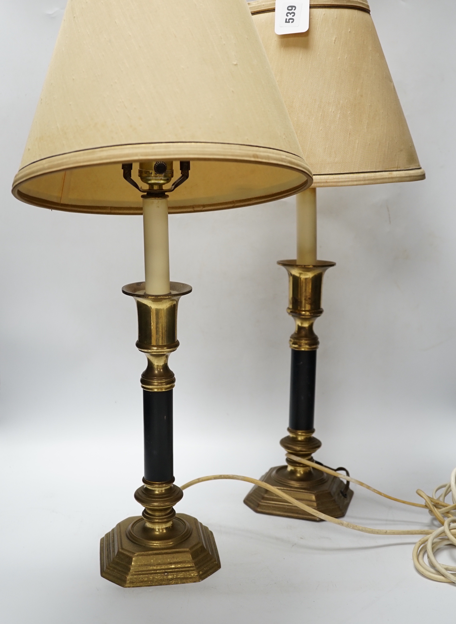 A pair of brass and black table lamps and shades, 64.5cm high